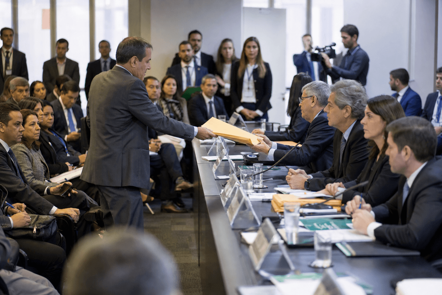 Officials receive bidding documents during a Brazilian oil and gas auction session