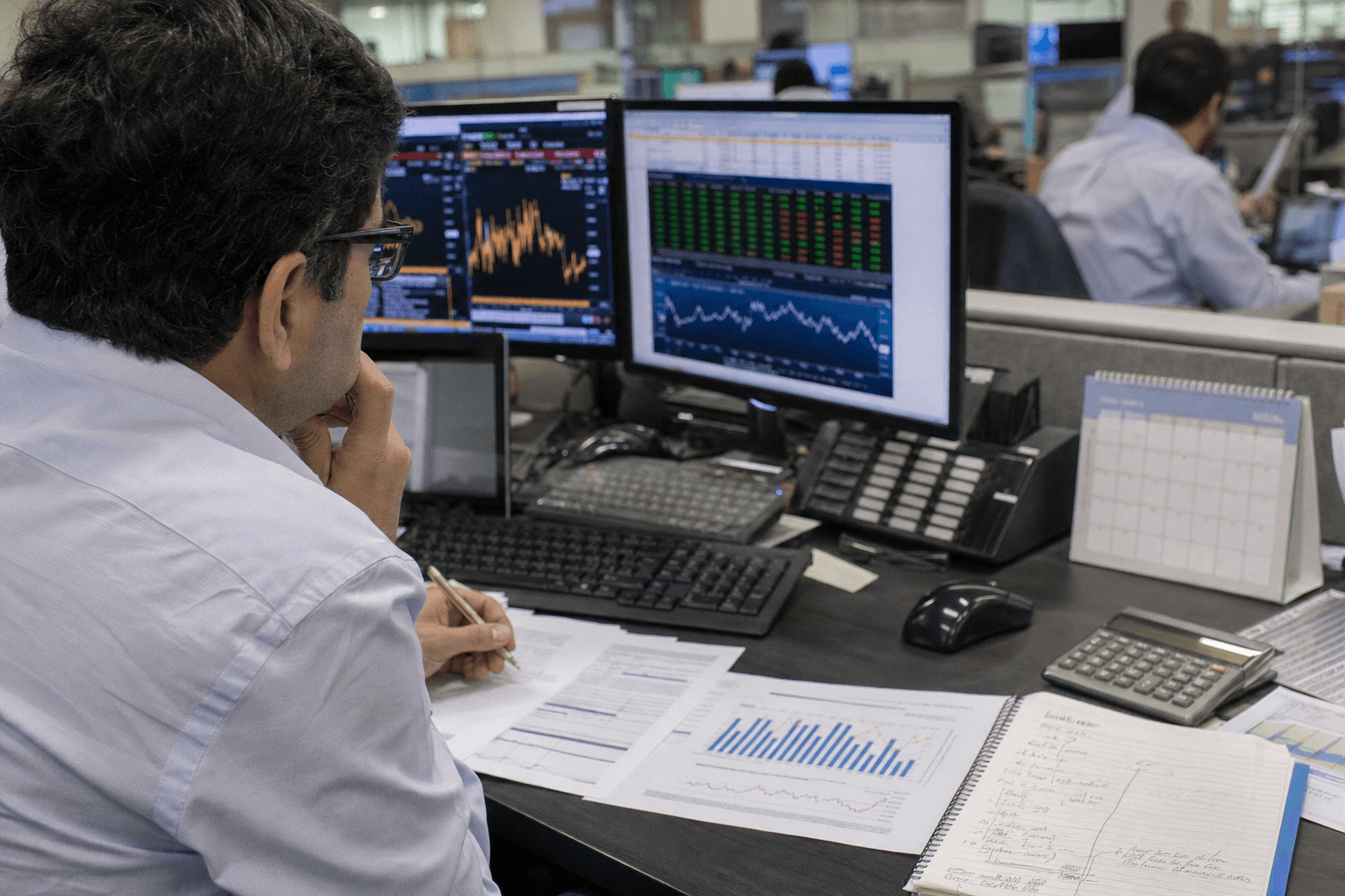 Financial analysts reviewing Brazilian economic data on office screens